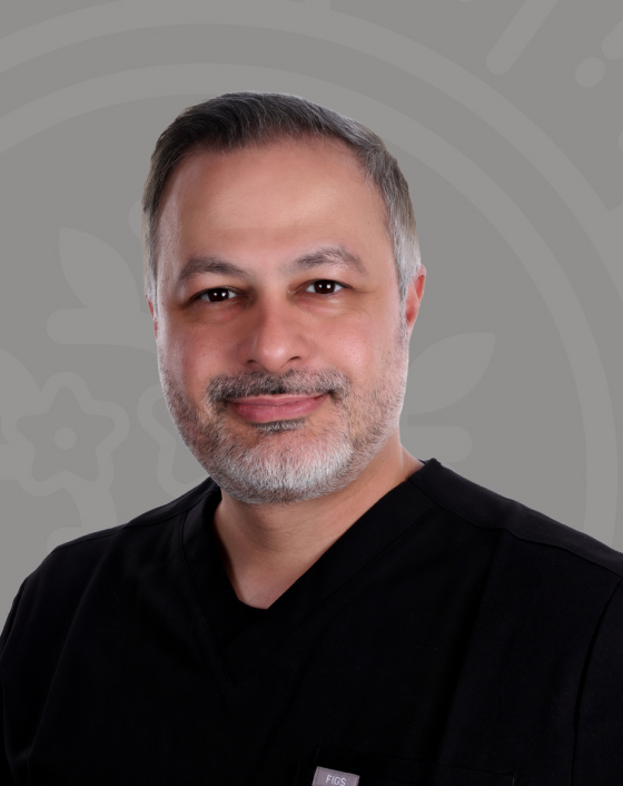 Dr. Amin Esfahani smiling in black scrubs